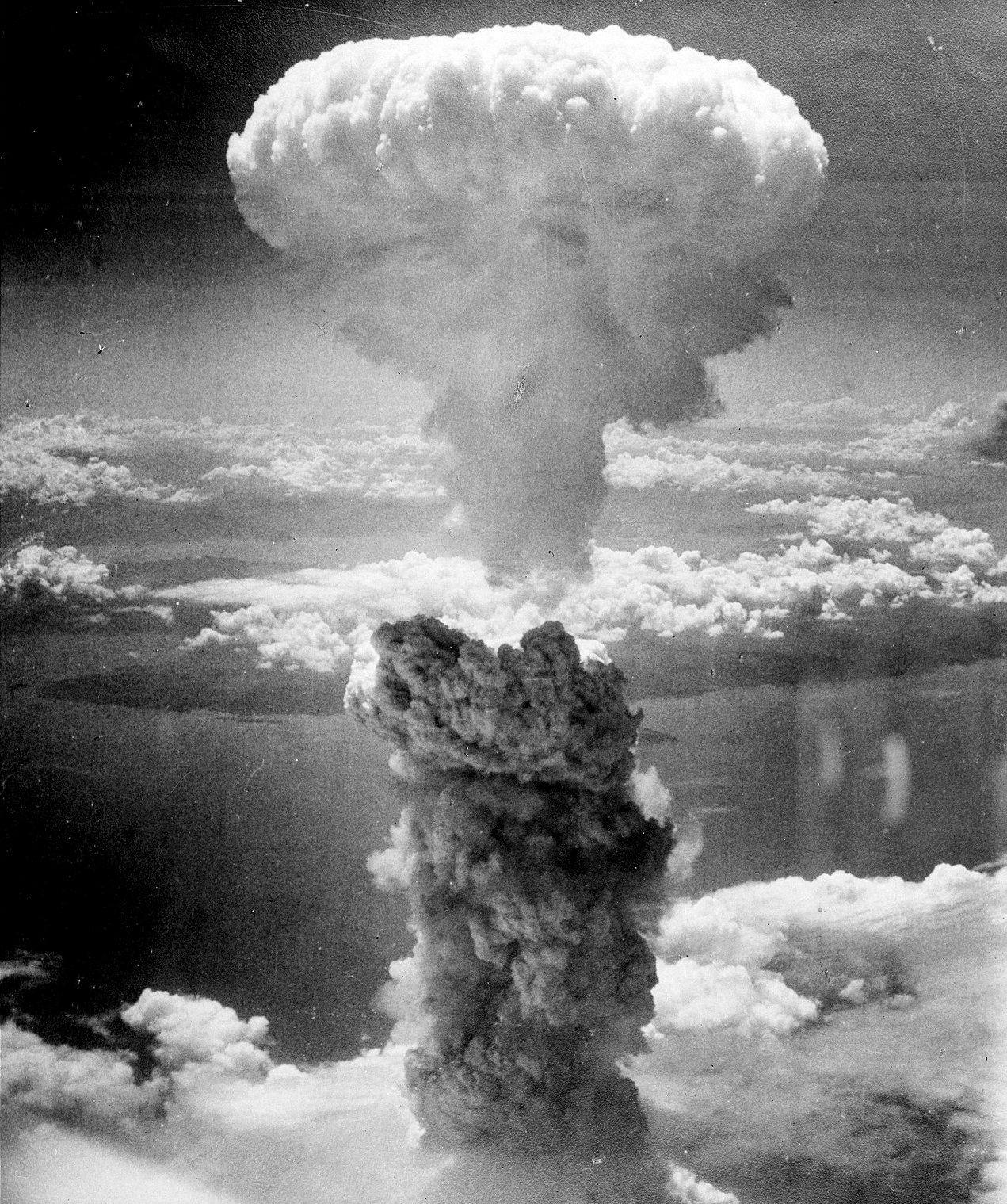 Black and white photo of a mushroom cloud resulting from atomic bomb explosion