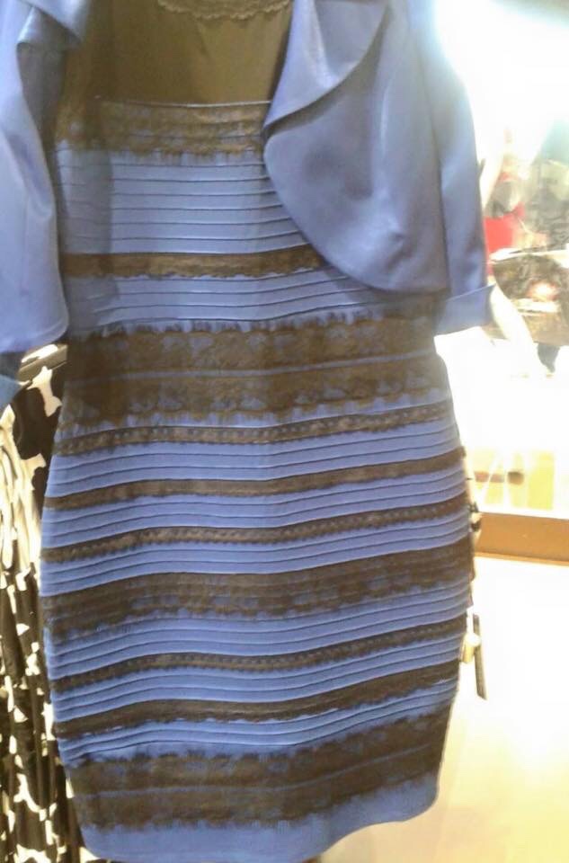 Photo of 'The Dress'. A grainy, poorly exposed photo of a hanging dress. Different people see the dress's colors differently, either black and blue, or gold and white.